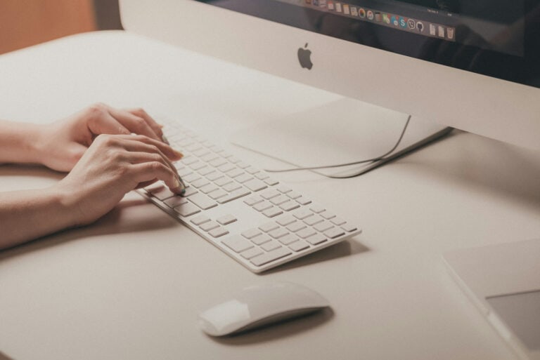 What Is Content Decay How to Fix Content Decay Issues | Person Typing on Computer | Cahaba Digital
